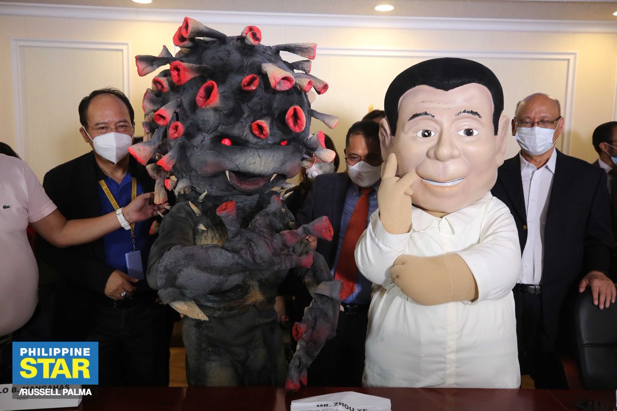 PhilippineStar's tweet photo. A mascot of President Rodrigo Duterte punches another mascot representing the new coronavirus during a press conference of a joint movement pushing for free COVID-19 vaccination on Wednesday. https://t.co/Iu197K0UkK