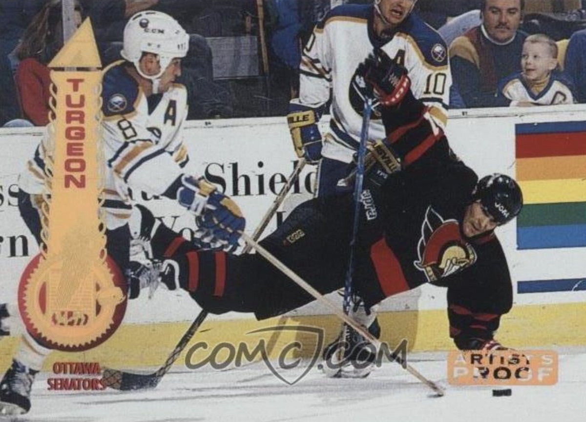 sportslogosnet's tweet photo. The little kid sitting in the stands of this hockey card has won three more Stanley Cups than the combined total of the two teams playing on the ice https://t.co/zMpKX1oqPM