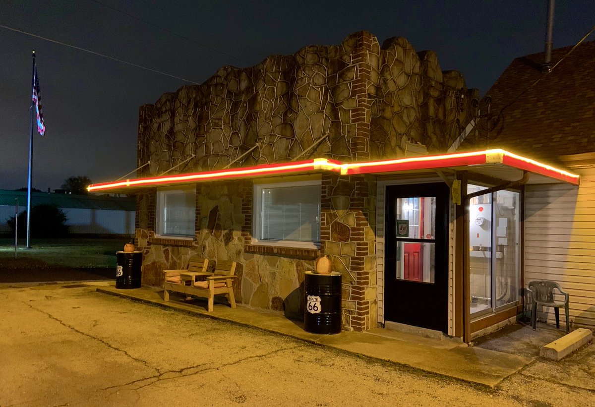 CourtMotor's tweet image. The filling station takes on more life - a bright red door and yellow neon! #route66life