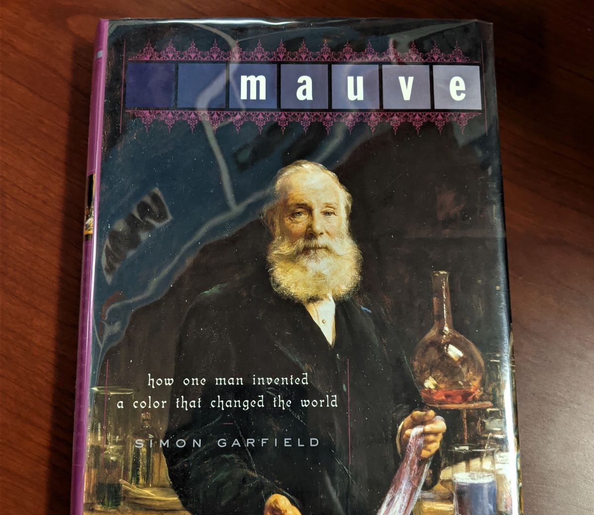 The book "Mauve: How One Man Invented a Color that Changed the World" on a wooden surface.
