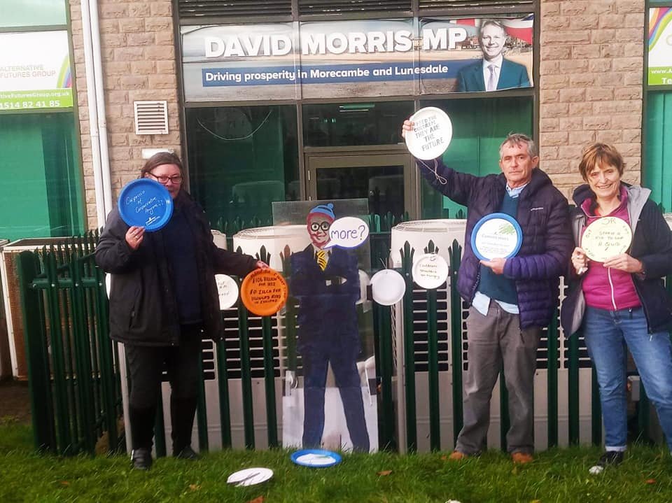 before_profit's tweet photo. Feed Hungry Kids! #EmptyPlateProtest outside the office of David Morris Conservative MP for Morecambe & Lunesdale. He voted against extending free school meals. 100s of families in Morecambe rely on food banks. In 2019-20 he claimed over £77,600 in expenses. #PeopleBeforeProfit https://t.co/dqrXLAyb7O