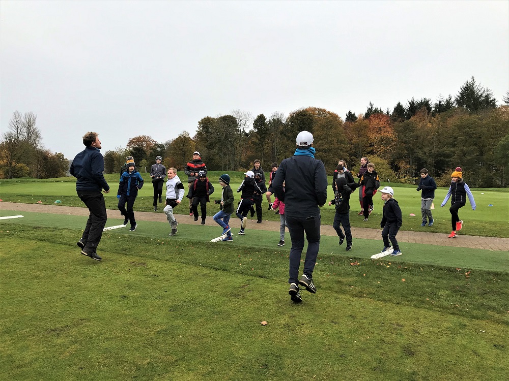 CloseHouseGolf's tweet photo. Knees up everyone! Our pros were keeping busy at the Academy today with an active warm up as part of our half term junior coaching sessions. Great to see so many young golfers out there #juniorgolf #grassrootsgolf #golfuk #girlsintogolf #closehouse #pga #pinggolfeurope https://t.co/qNfAJiWsXG