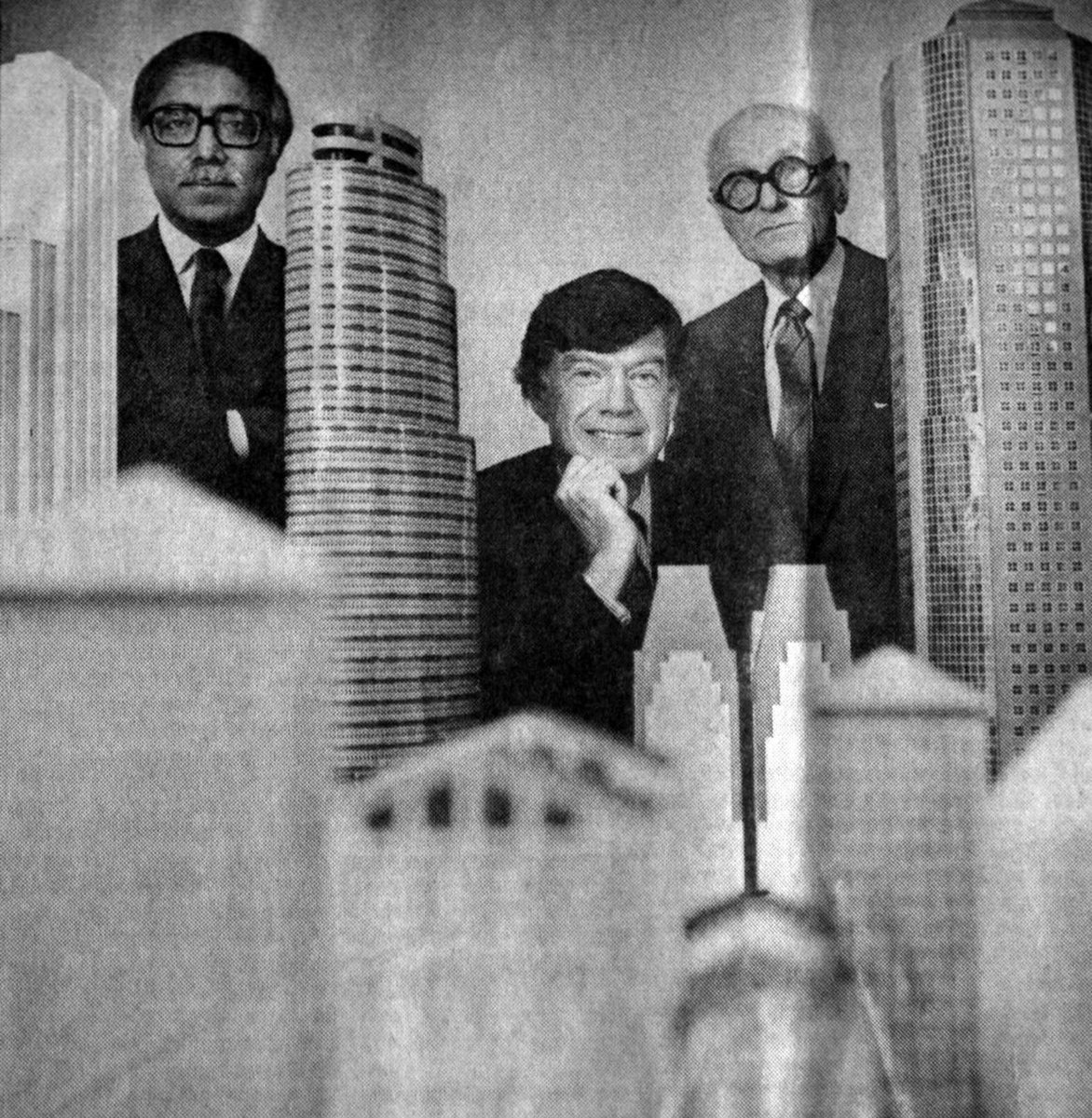 Philip Johnson, Raj Ahuja, and John Burgee in 1987 with a collection of models of their projects