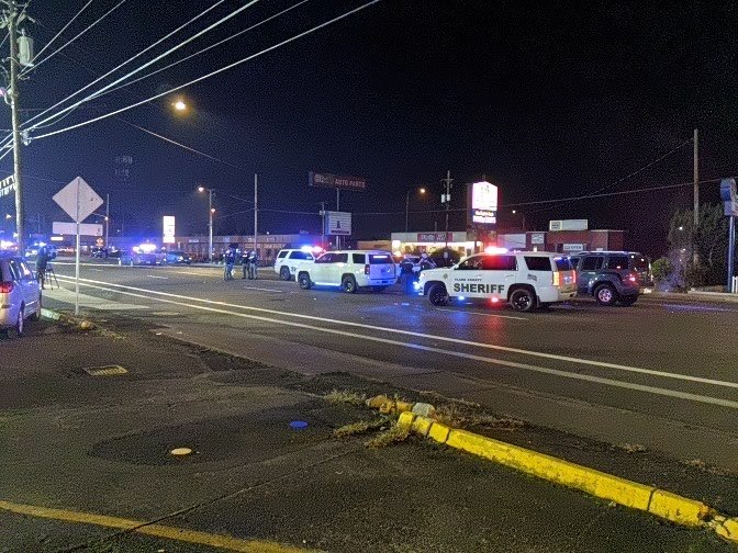 Sheriff's vehicles parked in the street.