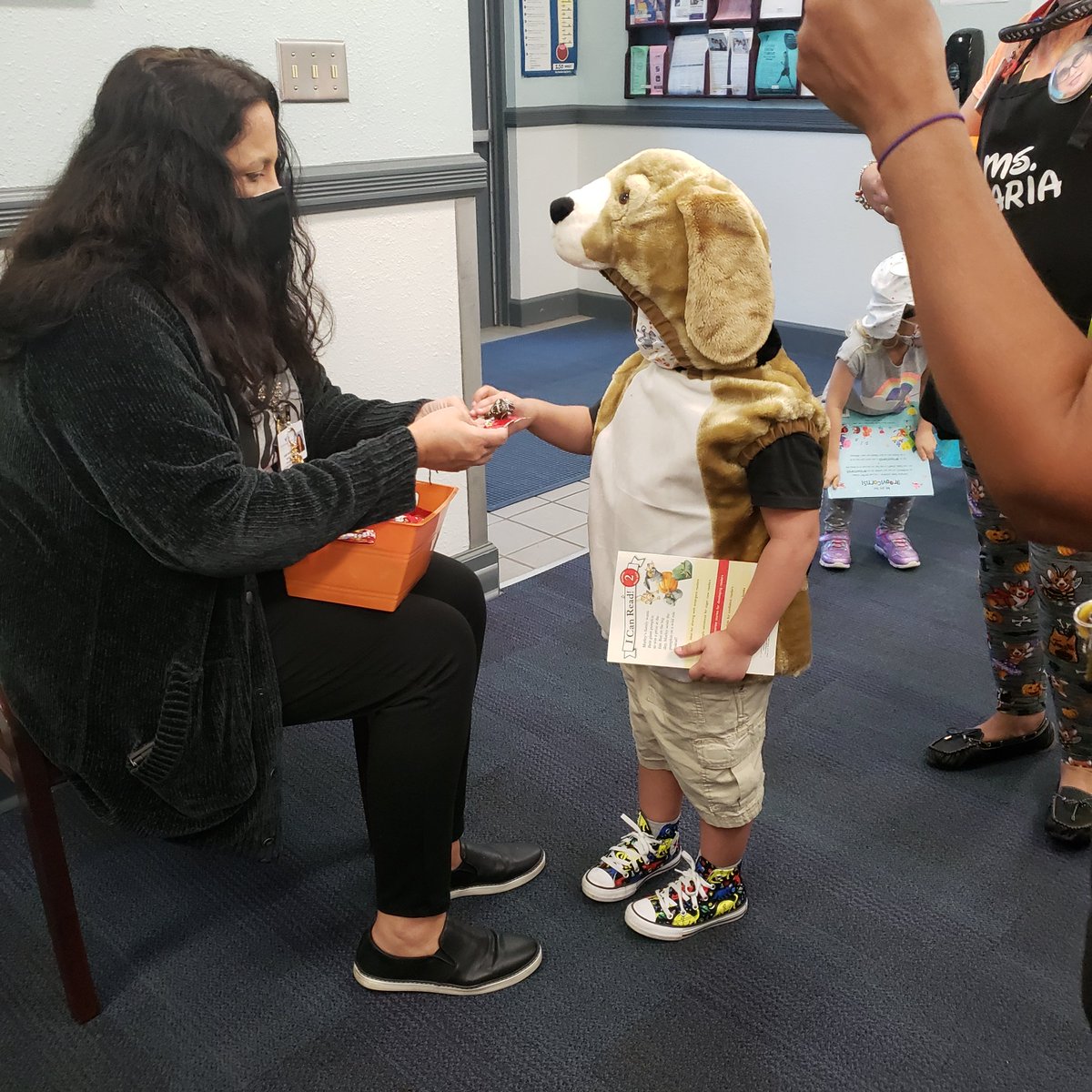 Ms. Perez is handing out candy for our Pre-k parade