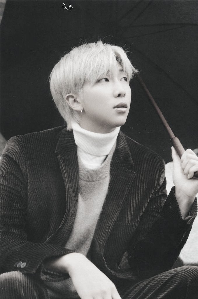 "Cuz the umbrella would cover the sad face": the umbrella is probably symbolic of the darkness that falls on removal of the limelight, in the superficial aspect, on a deeper note, it could be his own darkness, n our own individual darkness, that all of us, incl. Joon hold within+