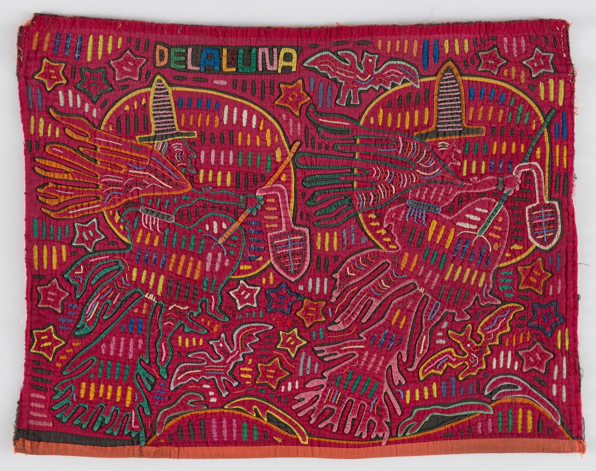 Mola textile panel with witches on broomsticks and bats.
