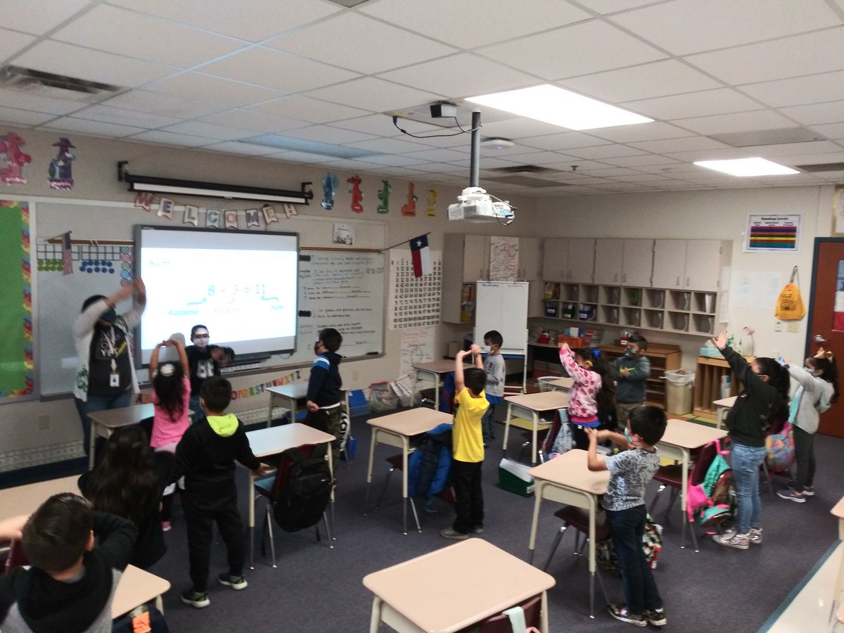 UAlvarez's tweet photo. Ms. Meza's first grade dual language class using total physical response to practice academic language and help students connect their math vocabulary in English and Spanish during a segment of the bridge. @BonnerTylerISD #A2D #BonnerDualLanguage #Mightybees https://t.co/Zl4bQn4UOK