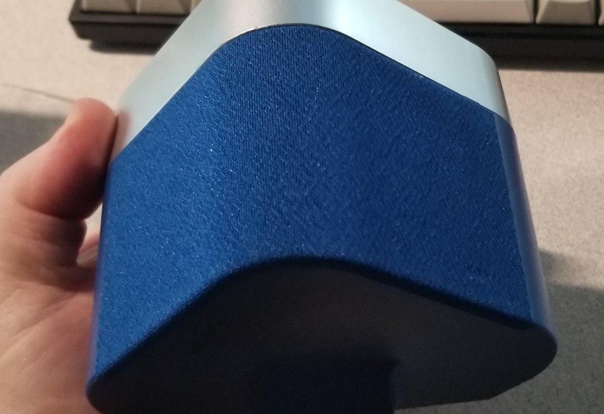 The back of the device looks like a fabric speaker grille. Not sure if there's one or two speakers under here, there's plastic right behind it and it's too opaque to see even with a flashlight.