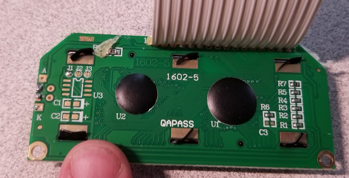 It's got two blobbed ICs on the back (booo)1602-5 and 200705AAY... apparently this is a HD44780-based module.