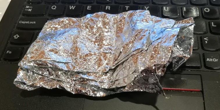 This is some actual sheet material, mylar plastic with a thin aluminum coating. It felt very light and fragile (yet survived being passed around the audience). Making sheets in microgravity would be even better. Avoiding tears requires clever design.