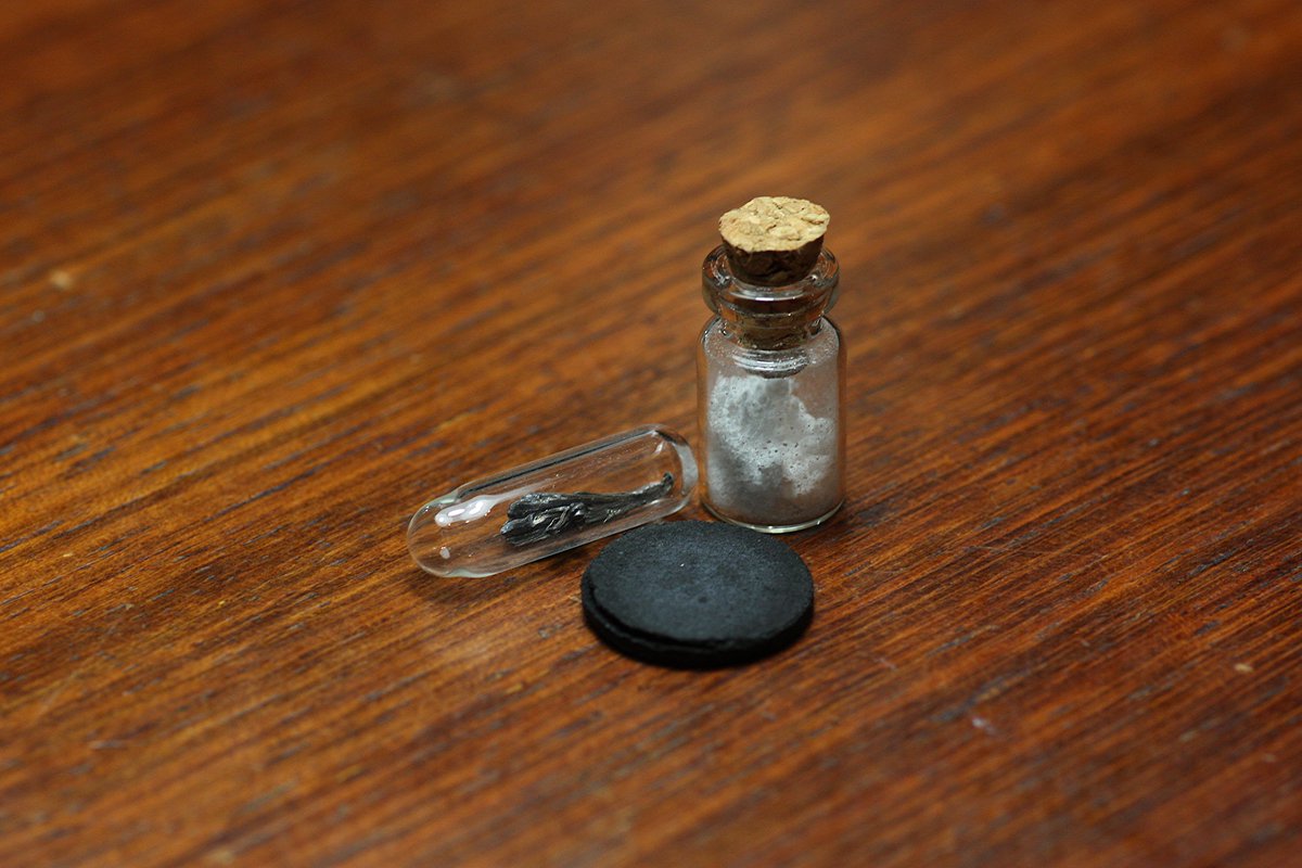 Barium  #elementphotos. White compound is barium carbonate (BaCO3), while the black pellet is a 123 superconductor (YBa2Cu3O7-x) with a critical temperature of 95 K.