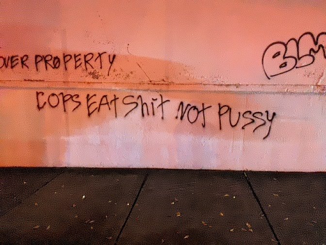 "Cops eat shit not pussy" in spray paint