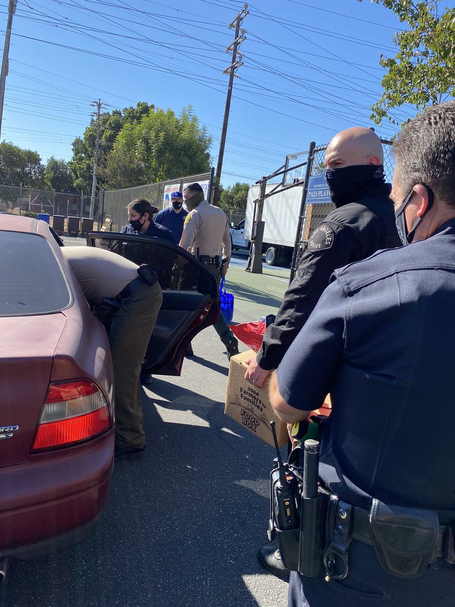 Los Angeles County Sheriff Deputies and Los Angeles Police Officers donating food at drive thru food drive in Northridge.