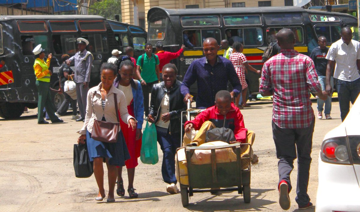 Family having to walk through busy road due to lack of pavements. 