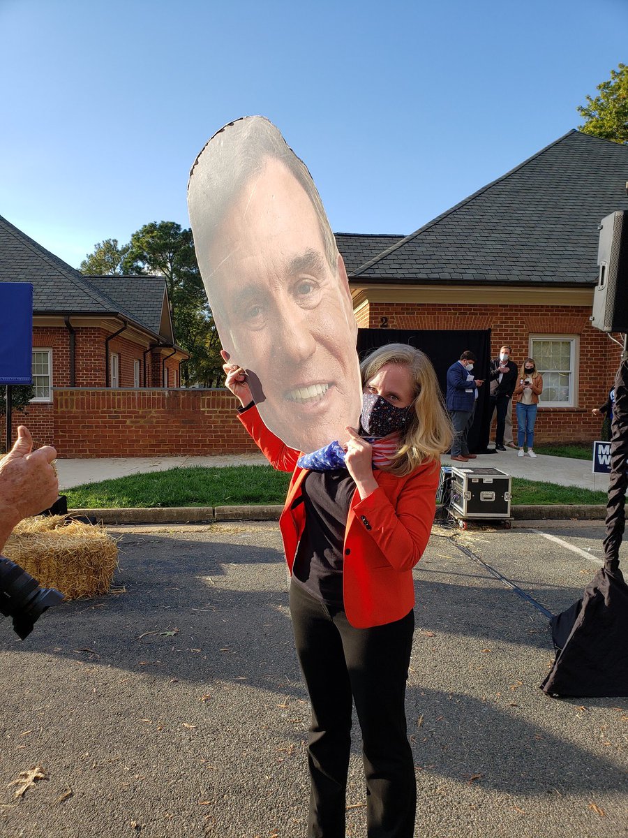 Rep. Spanberger stands with a picture of Mark Warner.