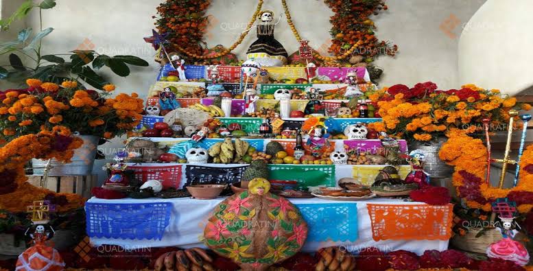 the food in the ofrenda has it's own meaning, the bread (bread of dead) or pan de muerto represents, the skull and bones, candy skulls with the persons name, and food that they used to love in life. flowers will guide them to their ofrendas along with water.