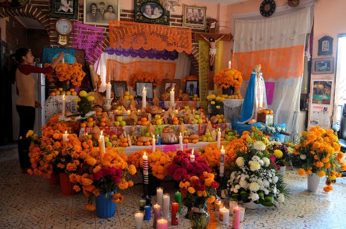 the food in the ofrenda has it's own meaning, the bread (bread of dead) or pan de muerto represents, the skull and bones, candy skulls with the persons name, and food that they used to love in life. flowers will guide them to their ofrendas along with water.
