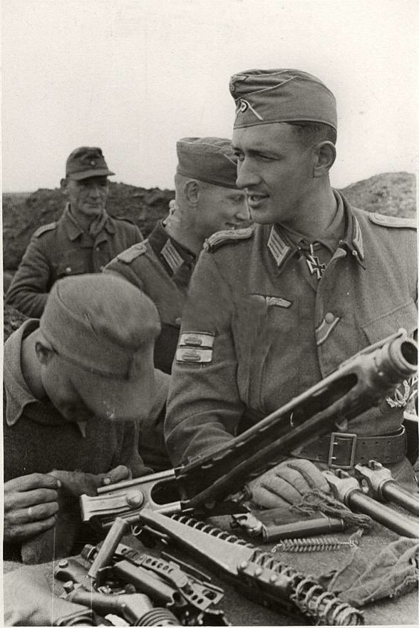 In looking at these 2 pics, the first shows the typical one body wide nature of German trenches in WW2.The second demonstrates the depth of the Mg Stellung protruding from the trench line, the start of which we see by Ott’s left hand in pic 1. 37f)