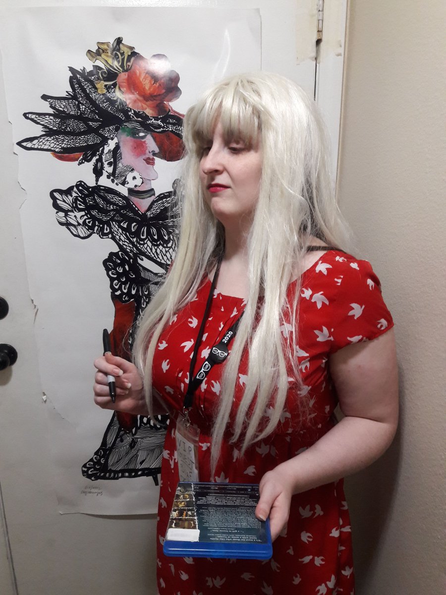 Actress at con waiting politely while extended canon is explained to her