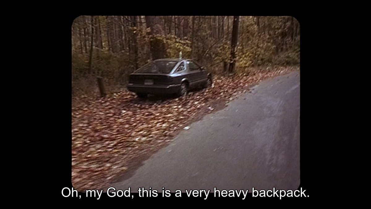 the film almost overplays its hand here—too ominous maybe to keep this constant looking-back towards the Car, which is clearly going to stay there (and in fact was featured heavily as Evidence in curse of the blair witch)—but that's a phenomenal restaging w/ actors walking past