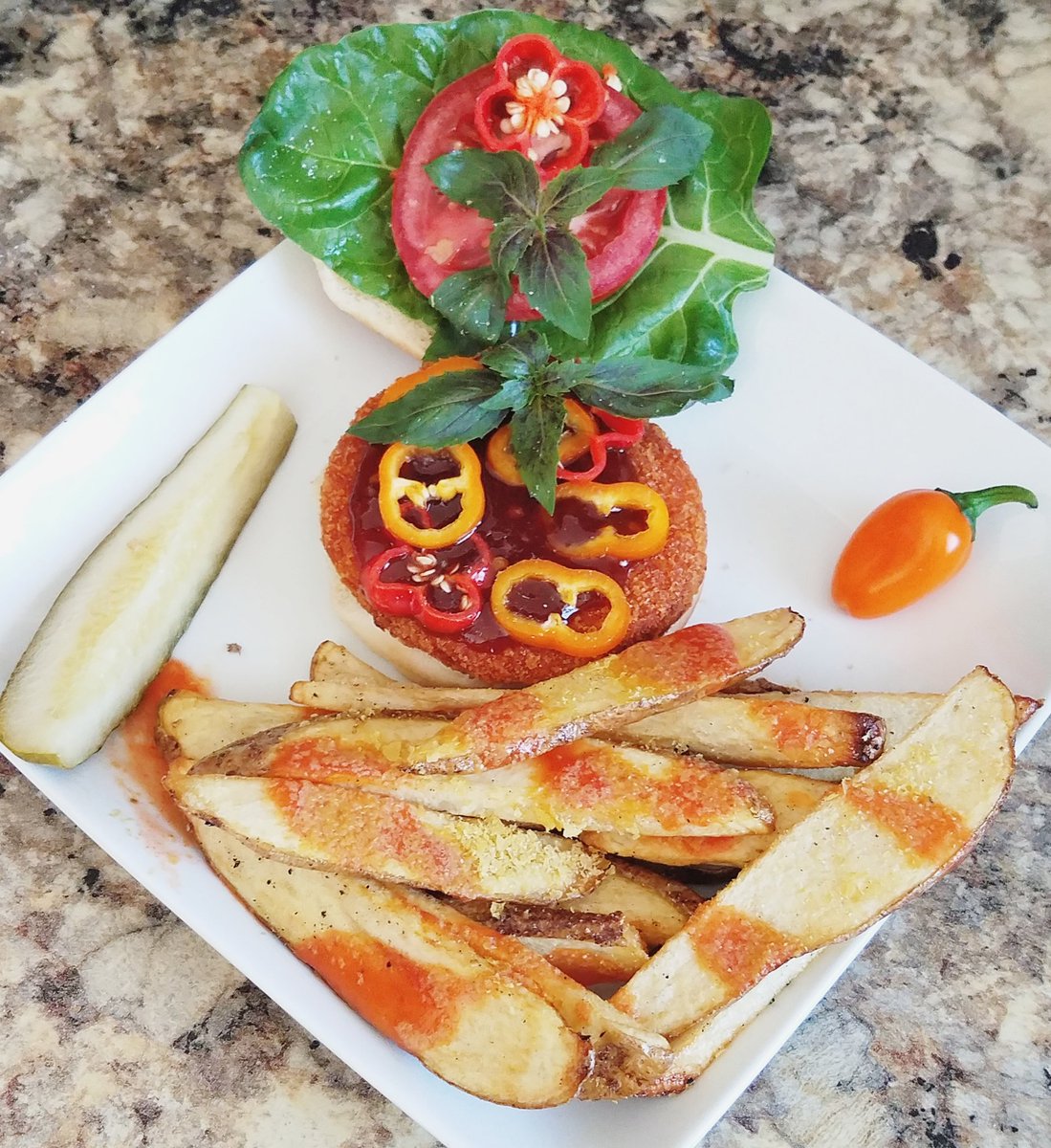 witnips's tweet photo. Morning Star buffalo patty, General Tso's sauce, tomato, basil, chard, mini sweet pepper and Caribbean red pepper. All veggies, greens, herbs except the tomato are from the little garden. Skillet fries topped with nutritional yeast and Frank's hot sauce. #basicvegan #simpleeats https://t.co/lphR6OAoI6