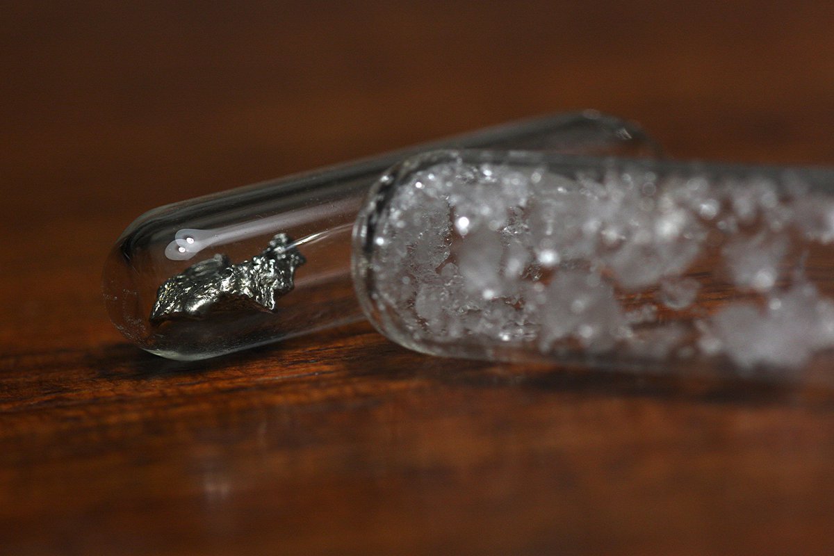 Lanthanum  #elementphotos. Like all the early lanthanoids, it oxidises easily. Though stored here in ampoules under inert atmospheres, oxidation is still apparent on at least one of the samples. White compound is lanthanum nitrate (La(NO3)3.6H2O).