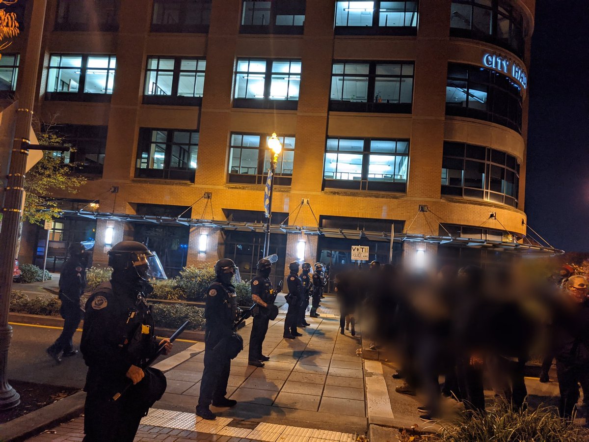 The group has reached Vancouver City Hall and was met with a line of riot cops.