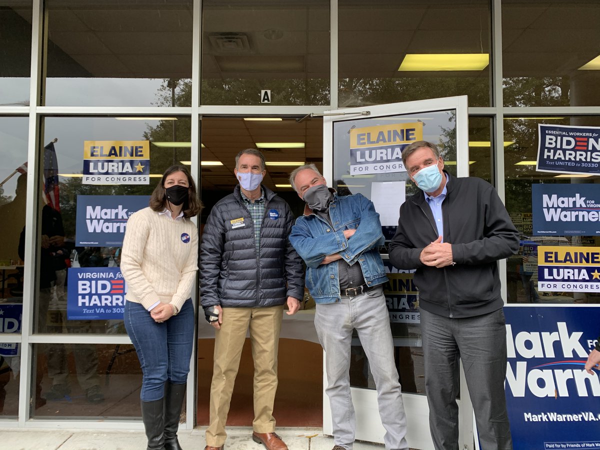 Elaine Luria, Ralph Northam, Tim Kaine, and Mark Warner stand outside of a Williamsburg office with campaign signs in the background.