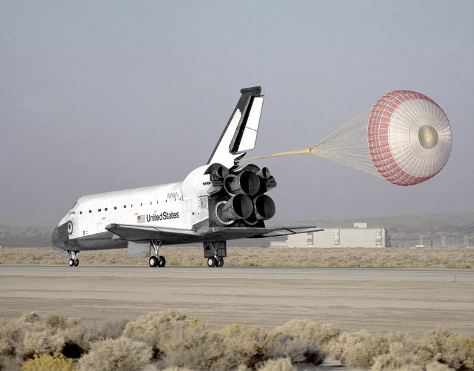 White space shuttle right after landing with drogue chute deployed. 