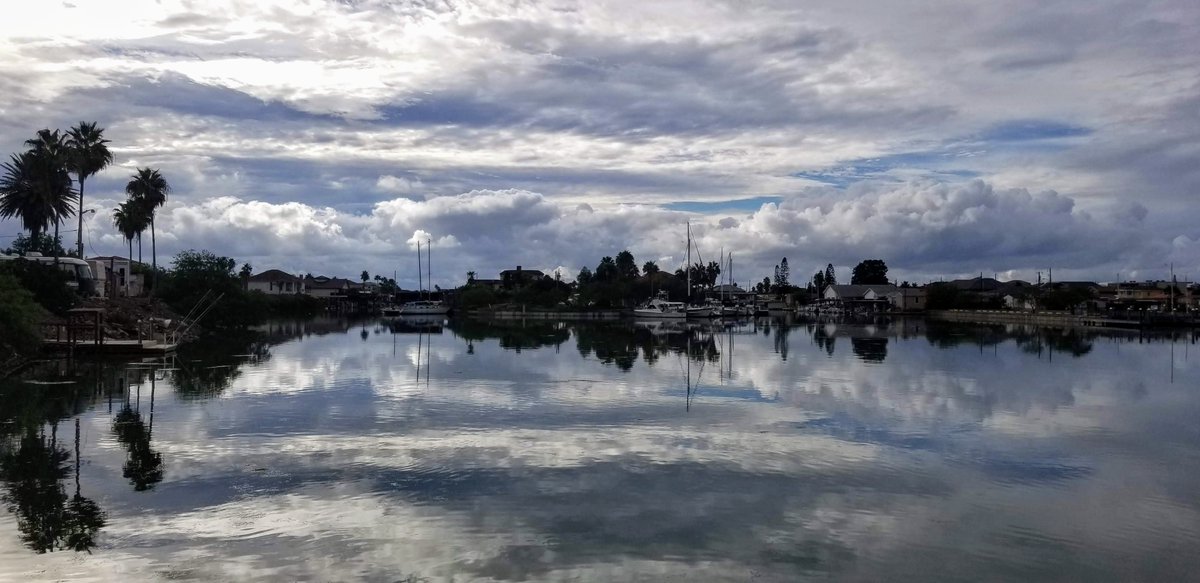 portisabeltexas's tweet photo. Port Isabel Side Channel... A look back at a day so calm that the sky was perfectly reflected in the water.

#portisabel #portisabeltx #portisabeltexas #sky #clouds #boating #waterfront #palmtrees #reflection https://t.co/kqmwoR4U8A