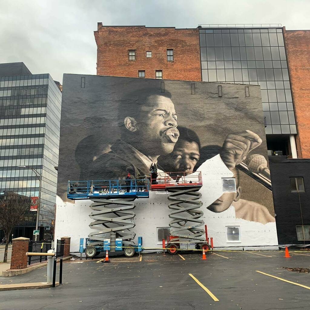 “I Am Speaking” 
Mural installation in progress by <a href="/akbar/">akbar</a>.paints <a href="/72and10/">PRL</a> @artbydiaz @danieljbueno. 
✨
A tribute to the late congressman John Lewis on state street in Rochester, NY. It’s been a privilege to witness this mural’s creation and am gratef… instagr.am/p/CHqsquFhqDK/