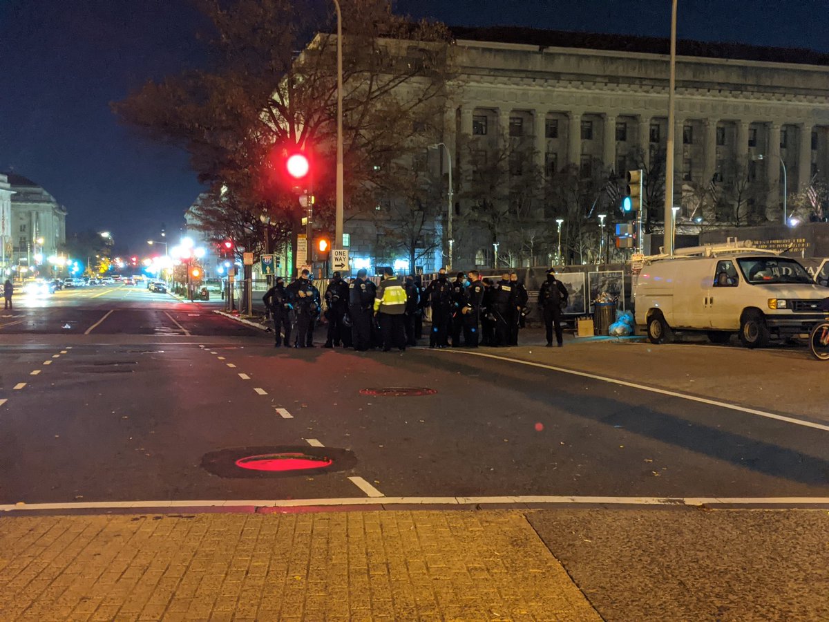 I arrive at a small group of Trump supporters hanging out outside a hotel. In the distance, two large groups of cops wait in the shadows