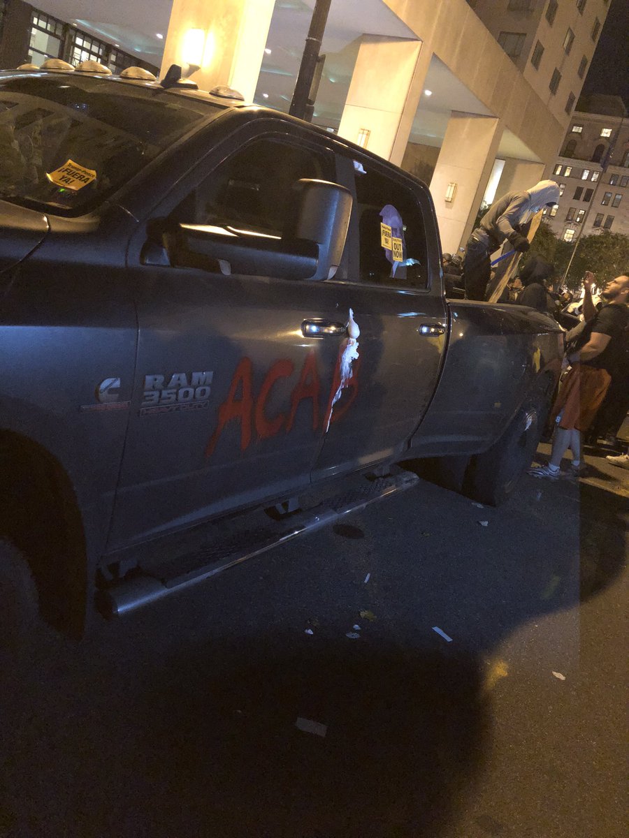 Counter protesters defaced this truck, which had a red Trump hat on the dashboard. They also slashed one tire