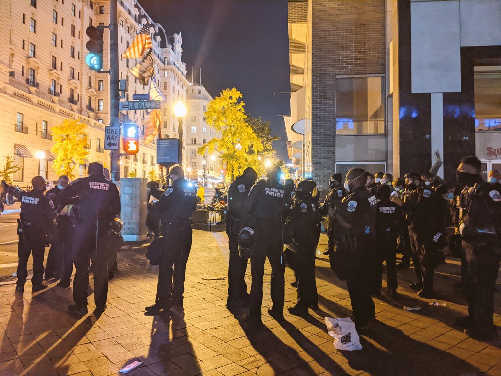 The cops, who seem to be escorting the Trump supporters, cross the street and remove their helmetsIs it because I'm in DC? Is it because it's the far right? What is this "remove our helmets"?