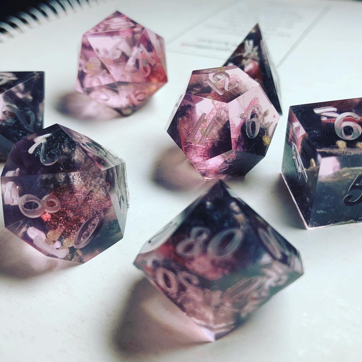 DSdicehoard's tweet photo. First set from the new mould made for a friend’s character a tiefling druid with black and pink colour scheme. (Not sanded, not painted.) #dice #dnd #tieflingdruid #clickclacks #dicegoblin https://t.co/LsbidMM68O