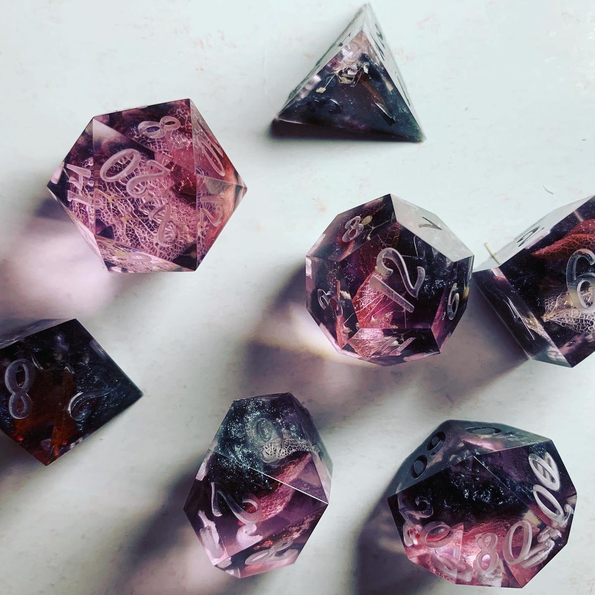 DSdicehoard's tweet photo. First set from the new mould made for a friend’s character a tiefling druid with black and pink colour scheme. (Not sanded, not painted.) #dice #dnd #tieflingdruid #clickclacks #dicegoblin https://t.co/LsbidMM68O