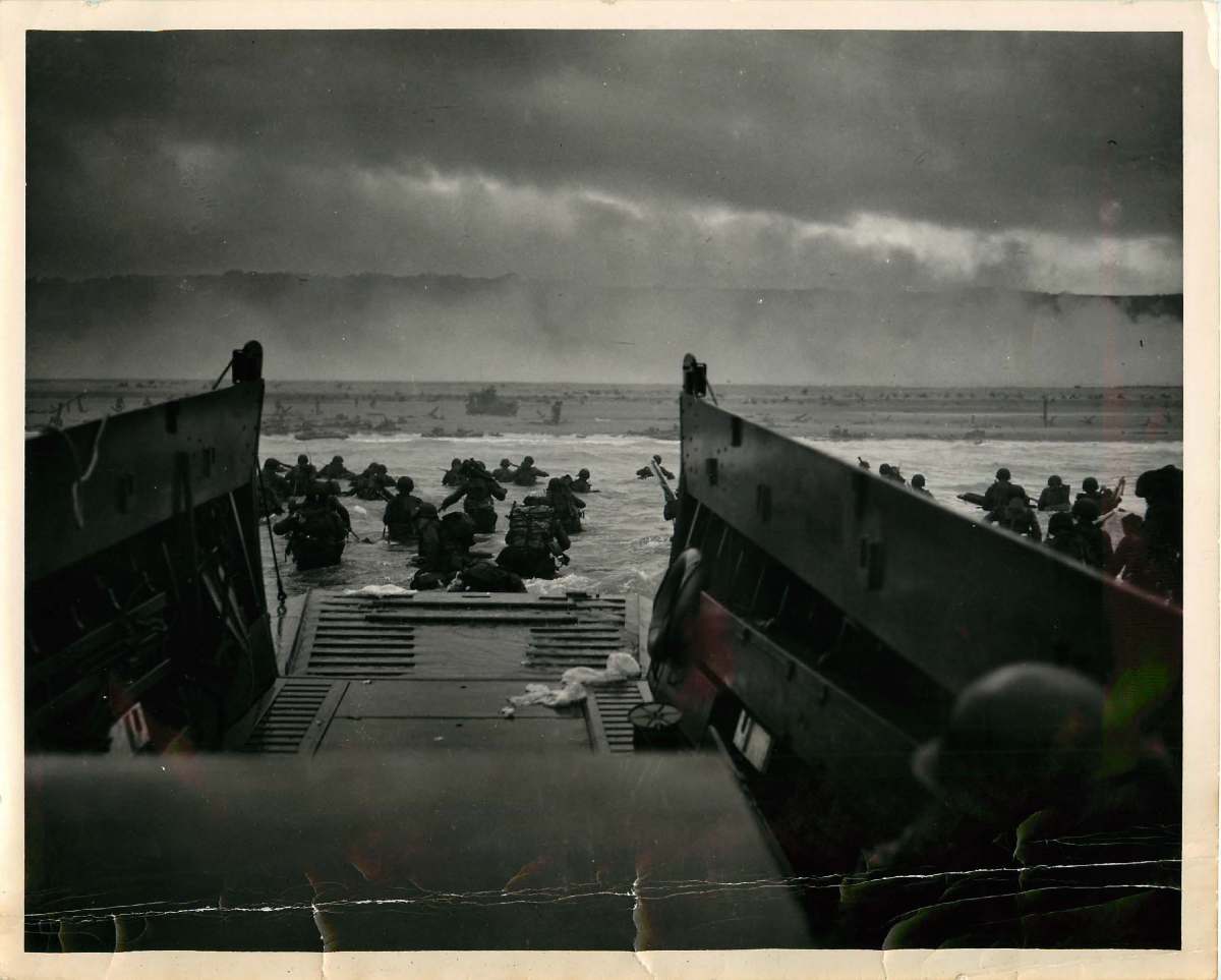 USCG's tweet photo. The most iconic photograph from D-Day is titled “Into the Jaws of Death,” shot by #USCG combat photographer, Chief Petty Officer Robert Sargent, from a landing craft approaching the beaches of Normandy. #SundayReading https://t.co/1vjxOGihGe https://t.co/zFh05bWJBn