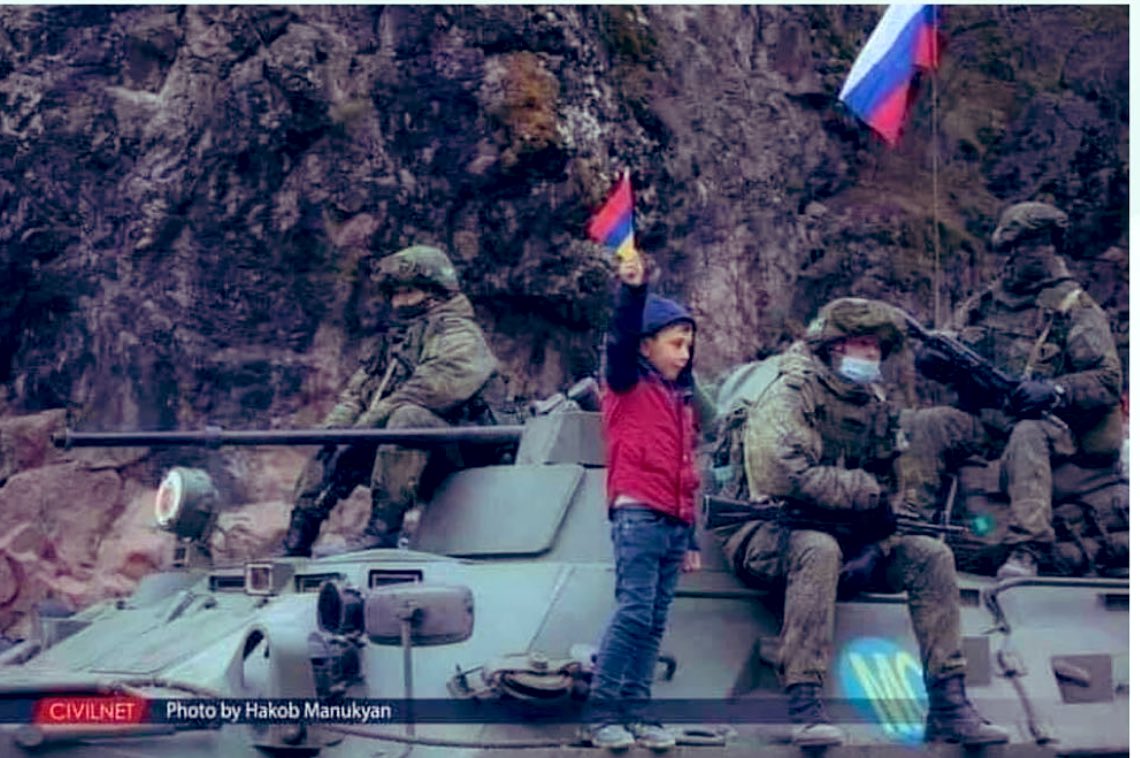 ANZHELA_YAN's tweet photo. An #Armenian boy is standing on a Russian tank with #Russian peacekeepers in Artsakh and proudly holding up the Armenian flag. 
#RecognizeArtsakh https://t.co/4UemGQMYqK