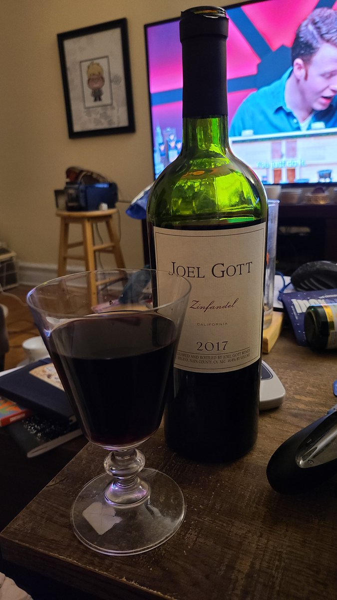 a bottle of zinfandel and a glass full of red wine