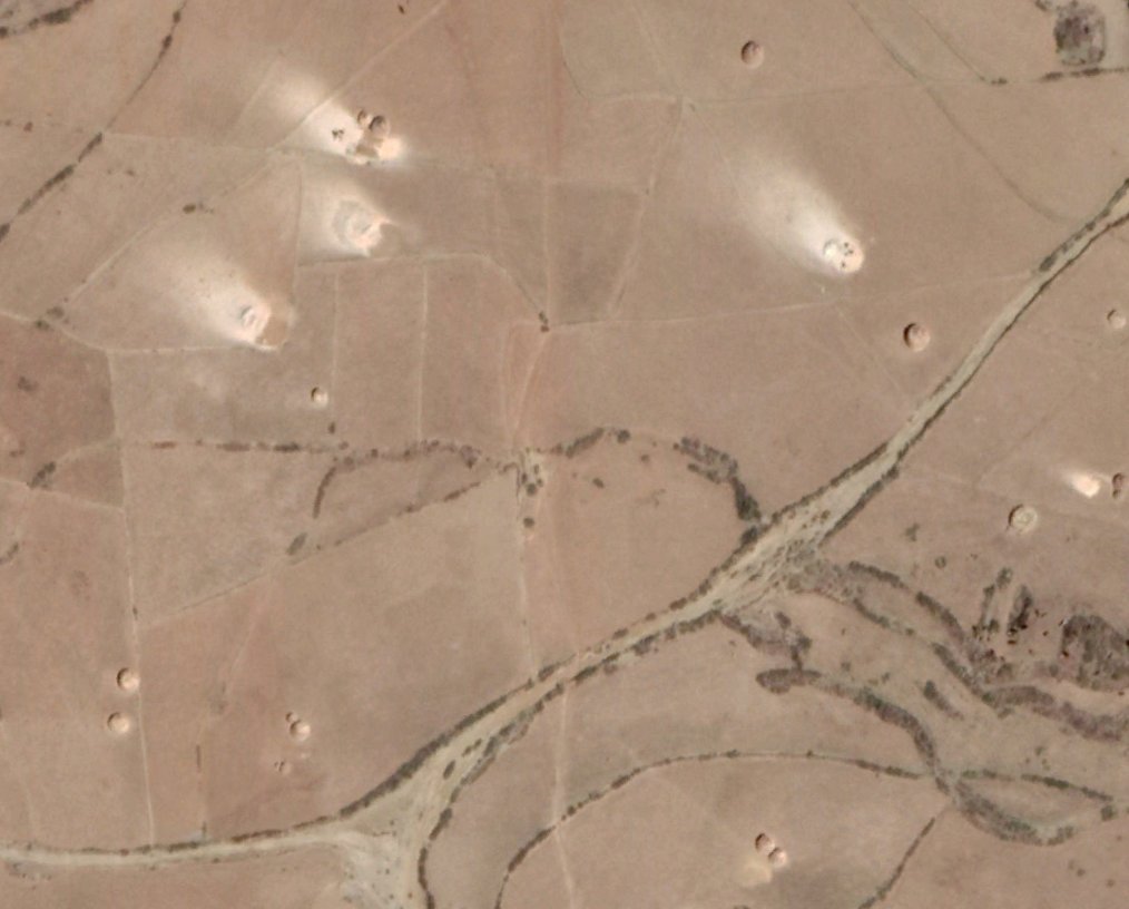 ...Looking at higher resolution imagery from previous seasons (here in 2018 again) you can actually see that those marks are drying areas for crops that have just been harvested and piled up, that just happened to coincide with a major military offensive this year...