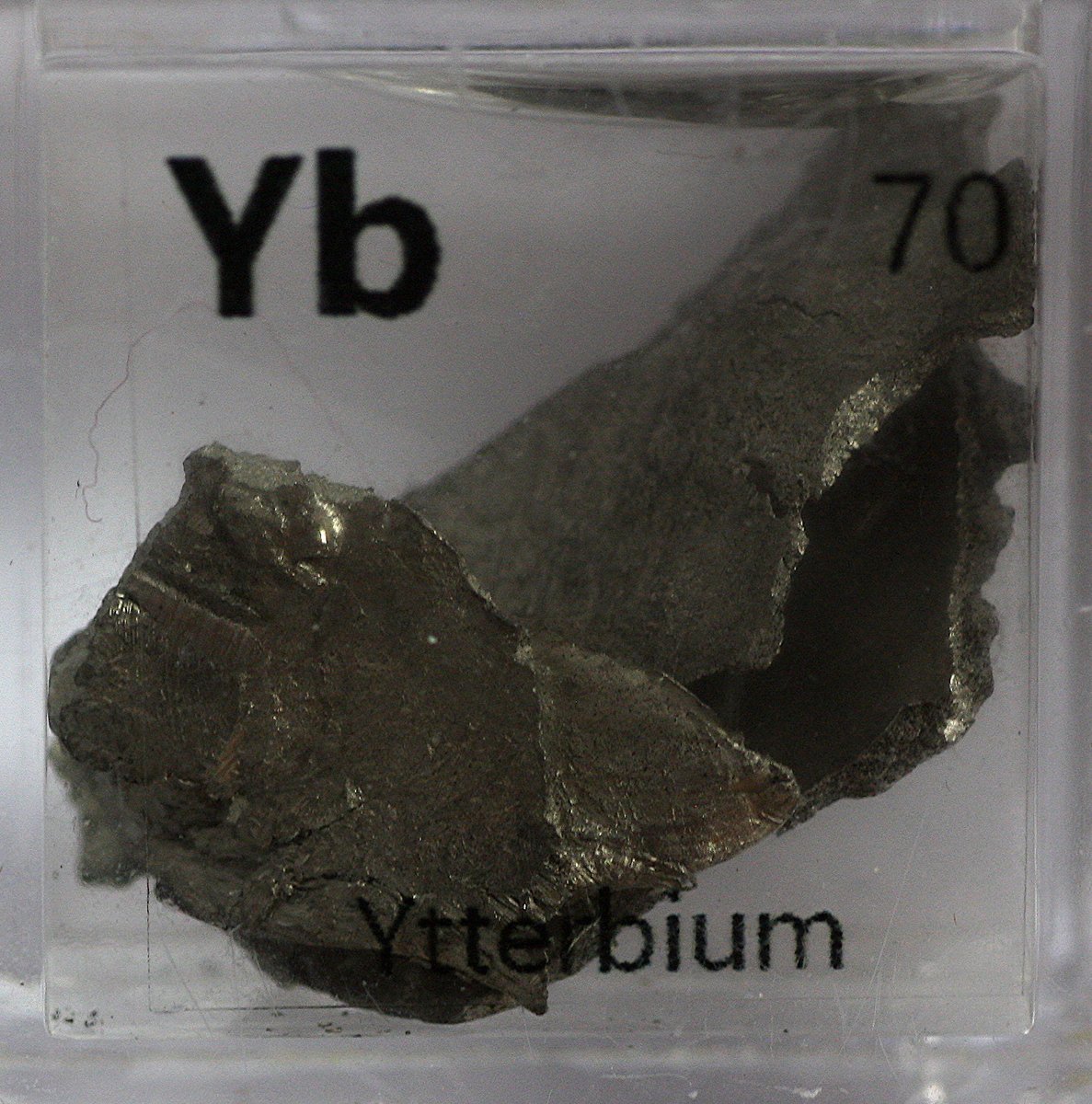 Ytterbium  #elementphotos. Elemental ytterbium is surprisingly soft (similar to zinc), has a lovely golden sheen, and I detected a faint 'burning' smell (likely due to slow oxidation) when cutting some into pieces. White compound is ytterbium oxide (Yb2O3).