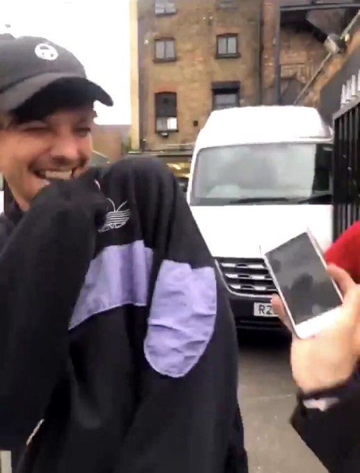 Louis Tomlinson covering his mouth while giggling;a soft thread