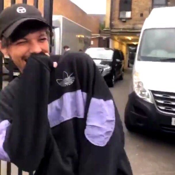 Louis Tomlinson covering his mouth while giggling;a soft thread