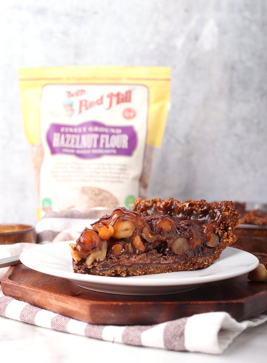 This chocolate hazelnut pie is perfect for the holidays. It’s like a classic pecan pie made with hazelnuts and finished with a chocolate bottom. Use <a href="/bobsredmill/">Bob's Red Mill</a> hazelnut flour and egg replacer for the perfect #vegan and #glutenfree dessert. mydarlingvegan.com/vegan-chocolat…