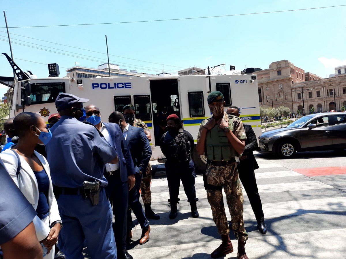 Numsa_Media's tweet photo. The management of #MafokoSecurity arrived to receive the memorandum, escorted by four heavily armed officers in camouflage uniform.
#SecurityGuardProtest https://t.co/dR460fUYu1