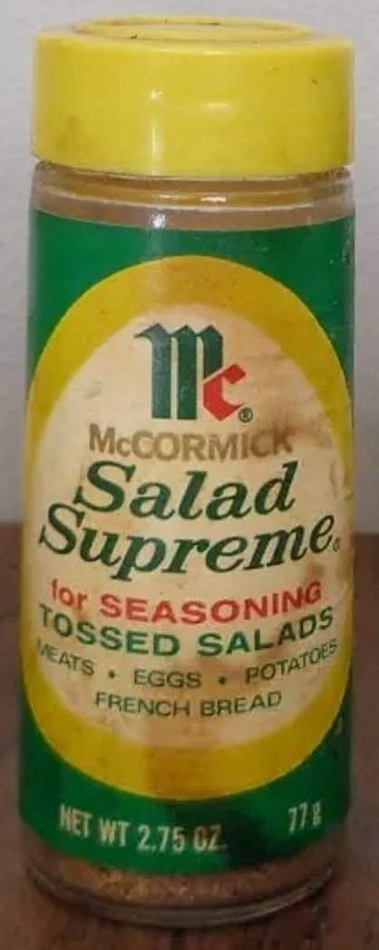 Adds a unique and delightful flavor to salad greens and tossed green saladsSalad Supreme tips (McCormick, ©1975, glass and tin, $1.29)