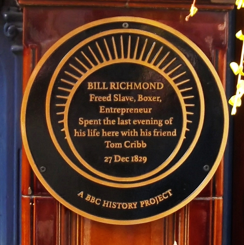 I don’t know who was the earliest Black publican in England but prize-fighter Bill Richmond (1763-1829) was certainly the most famous, he used his winnings to buy the Horse and Dolphin near Leicester Sq. The plaque was installed at his local on Panton St.