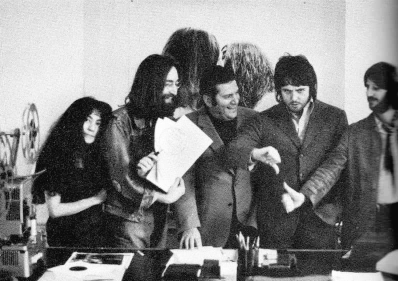 Paul, to keep face, posed with Allen Klein and his three bandmates in photos for the media. But he never signed any contracts that would tie himself to Klein officially.Look at him keeping face. He was so strong. He deserved so much better.