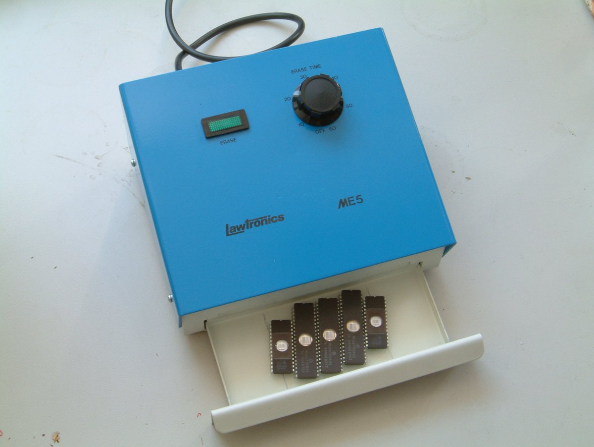 As for professional UV erasing, you'd have devices designed like this. Basically it's a fluorescent tube in a box, with a drawer and a timer.You put the EPROMs in the drawer, then set the time. It runs the light for that long, and then rings a bell or sets off a buzzer.